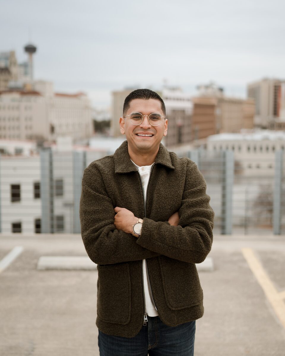 Nathan Mijares, CPA, founder of NM CPA & Advisory PLLC, standing on a rooftop with the San Antonio skyline behind him